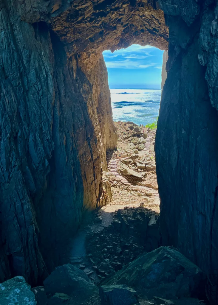 Torghatten reikä vuoressa ja taustalla merimaisema.